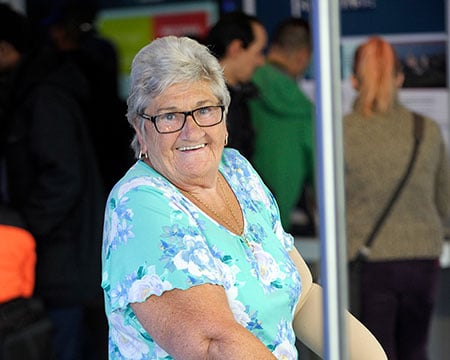A community learner interacts with the Powering the Future exhibits