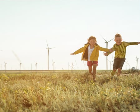 Grid image showing children infront of wind farm