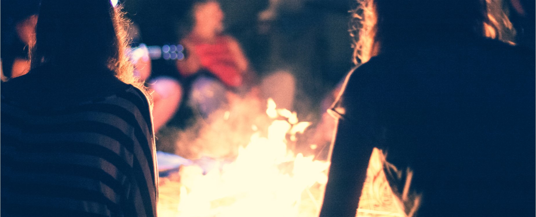 Banner image showing people round a campfire