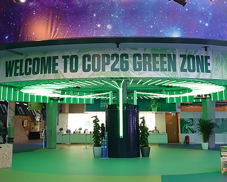 A sign around the underside of the Planetarium reads 'Welcome to the COP26 Green Zone'.