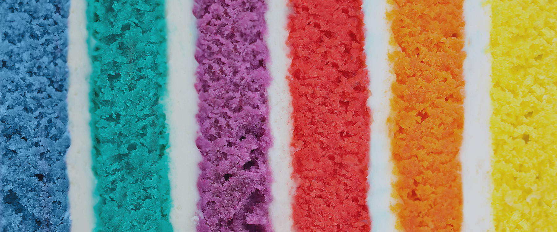 Colourful layers of cake separated by icing