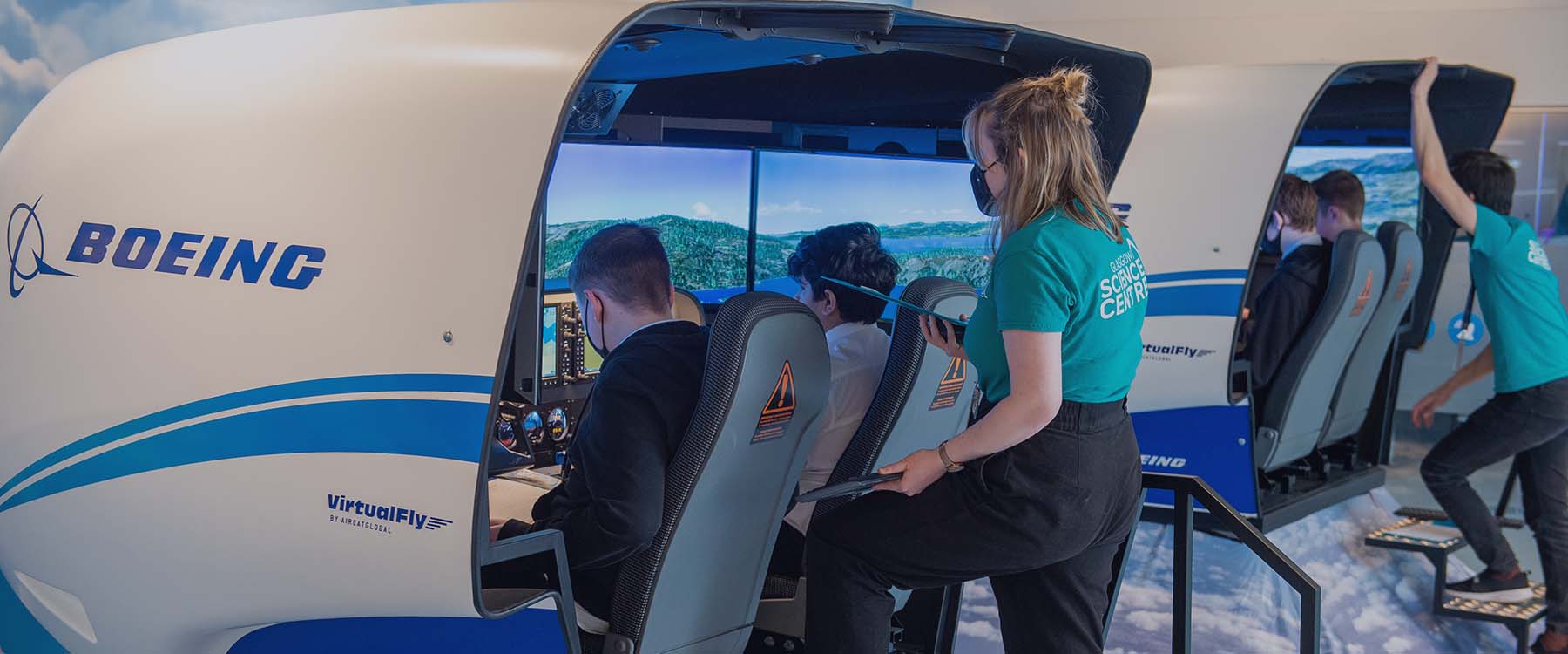 School pupils and flight instructors flying in flight simulators