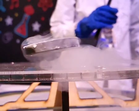 A super cooled magnet hovers above a track