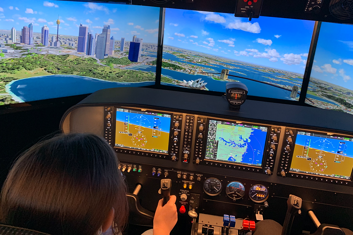 Person controls flight simulator through the skies of Sydney, Australia
