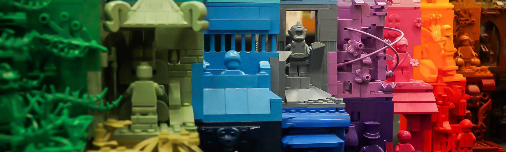Rainbow-colored LEGO vignettes from green to brown, each showing minifigures and detailed miniature scenes. Image: Courtesy of Brick M8