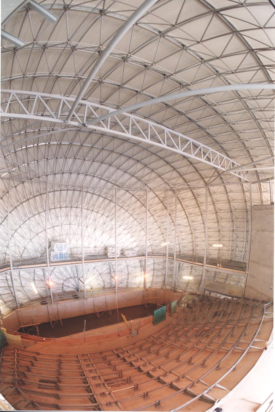 A photograph from 2000 shows the geodesic dome frame and internal space of the IMAX building being constructed.