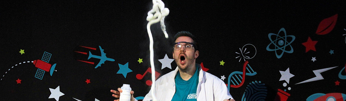science communicator looks shocked as the elephant's toothpaste experiment shoots into the air