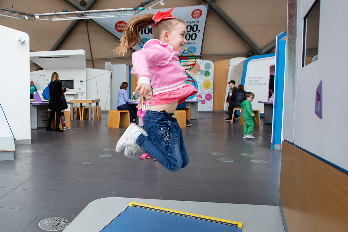 A child jumping on exercise exhibit at the BodyWorks exhibition