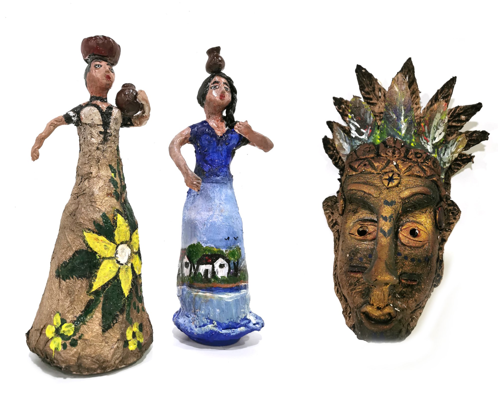 A mask and two figures made from recycled materials - the figures represent women from El Salvador, with baskets on their heads, selling fruit and the mask represents Mayan mythological art.