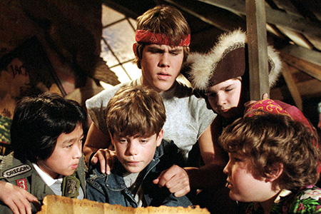 A groups of children huddled around a treasure map.