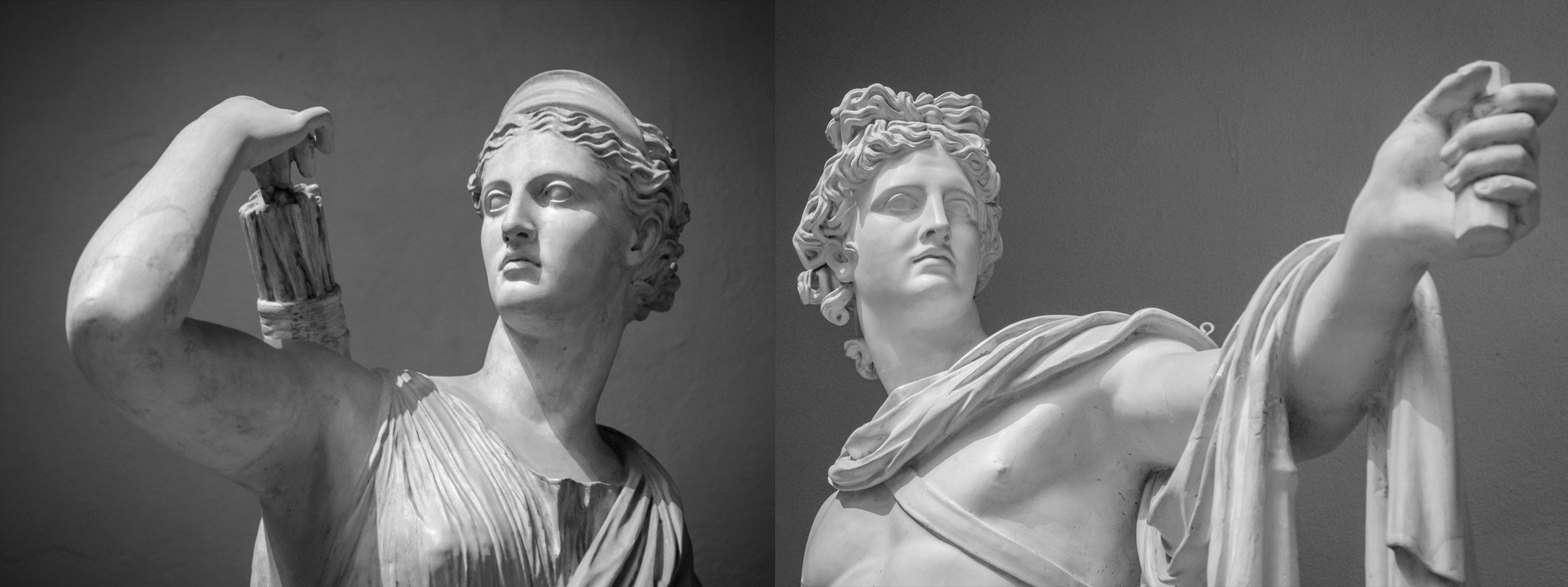 White marble statues of Artemis (left) and Apollo (right)
