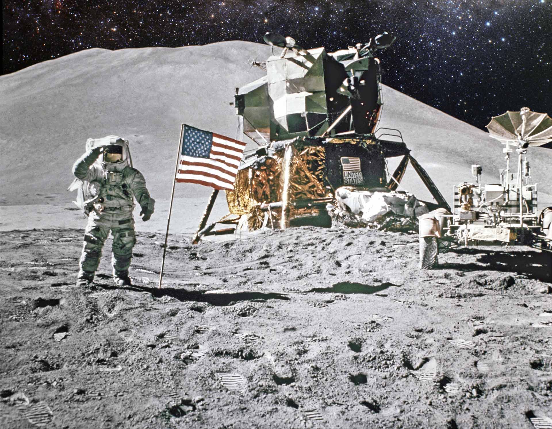 An astronaut on the surface of the Moon alongside the US flag, lunar lander and moon buggy.
