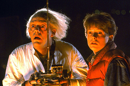 Doc and Marty McFly hold a remote control.