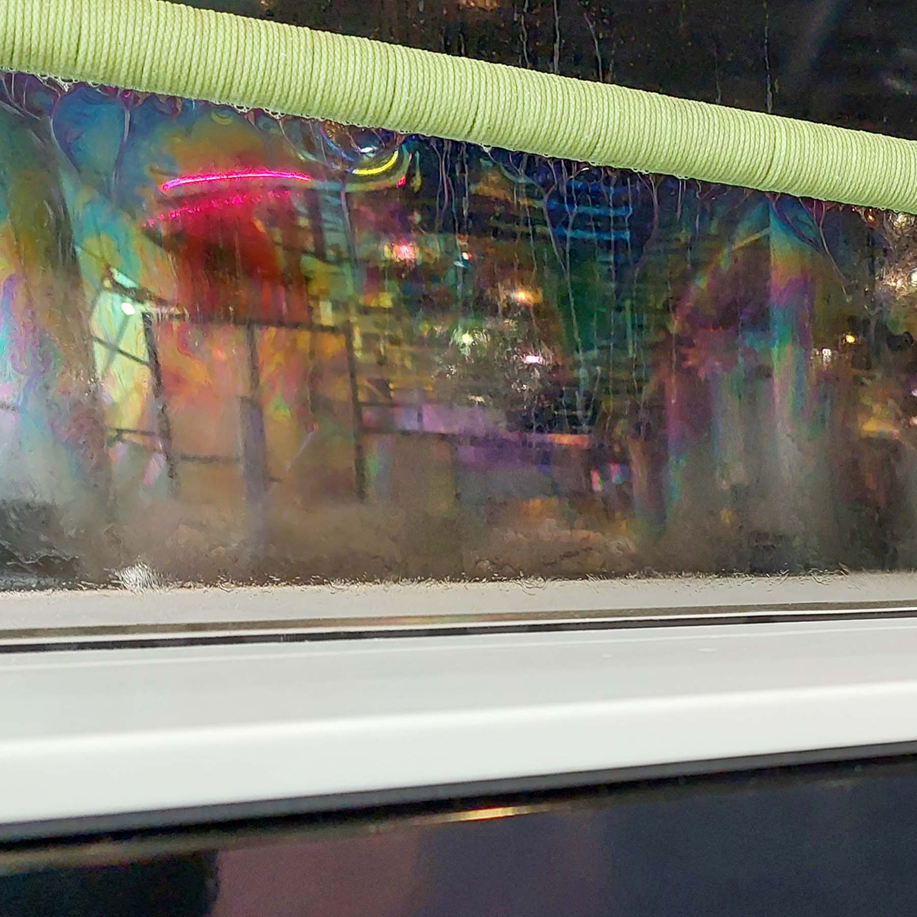 A thin film of bubble reflecting the science mall in a variety of colours.