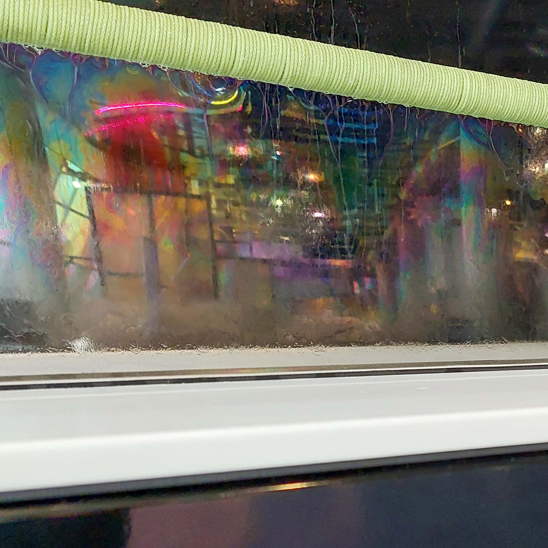 A thin film of bubble reflecting the science mall in a variety of colours.