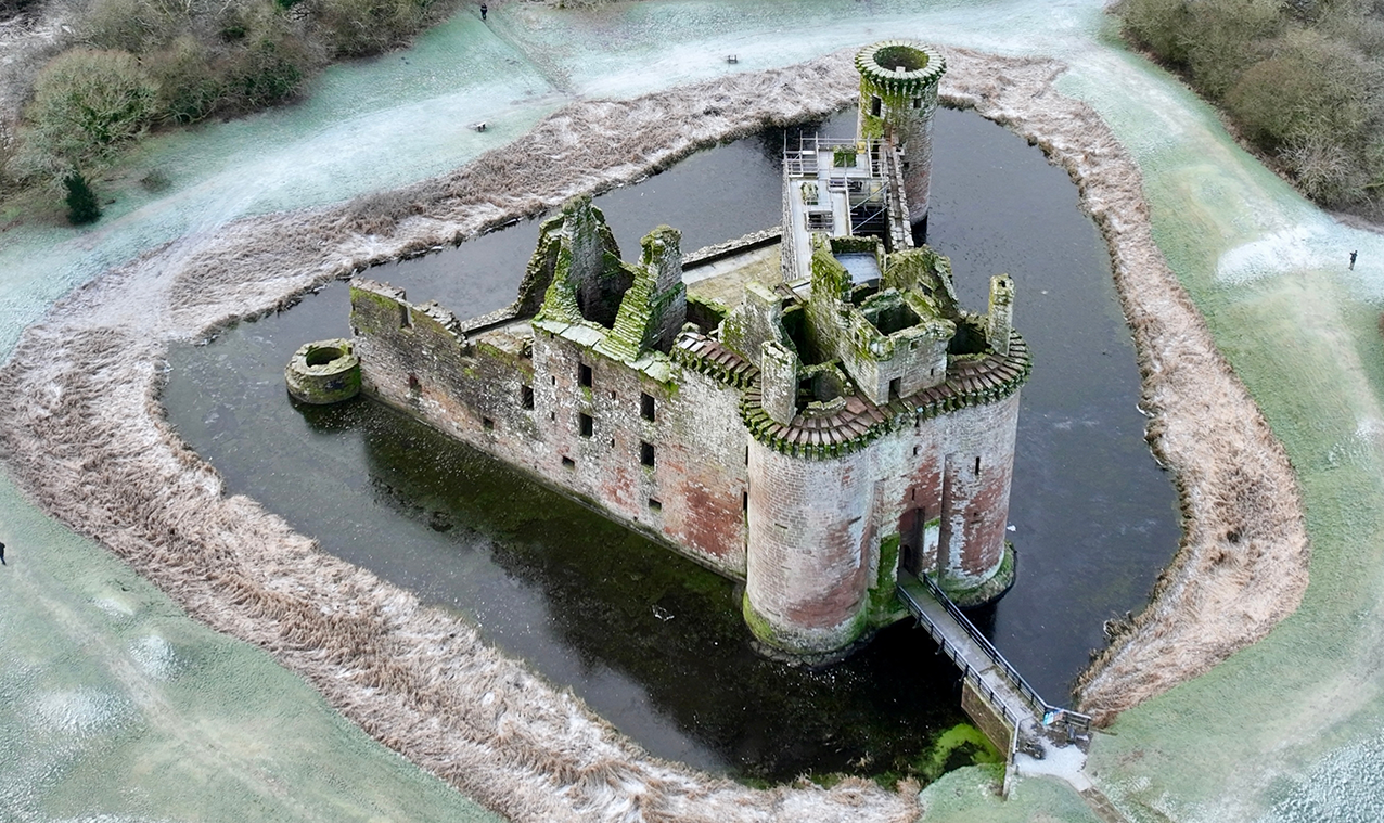 Caerlaverock Castle is a moated triangular castle first built in the 13th century. It is located on the southern coast of Scotland