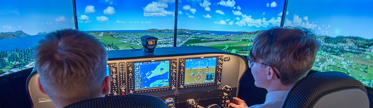 Two children at the controls of the flight simulator