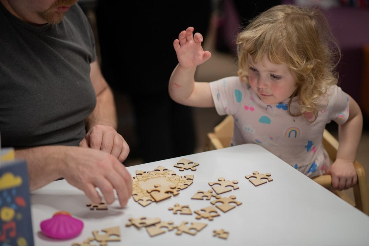 A young person makes a jigsaw puzzle
