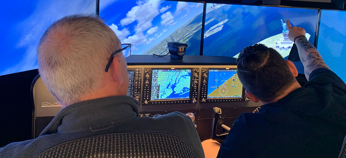 two people flying the full-motion simulator