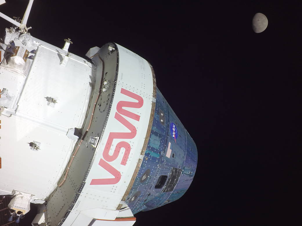 The Orion spacecraft with the Moon in the distance