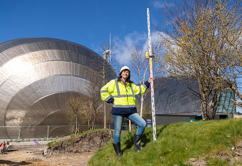 Dr Gillian Lang wearing a hard hat as improvement works begin outside Glasgow Science Centre