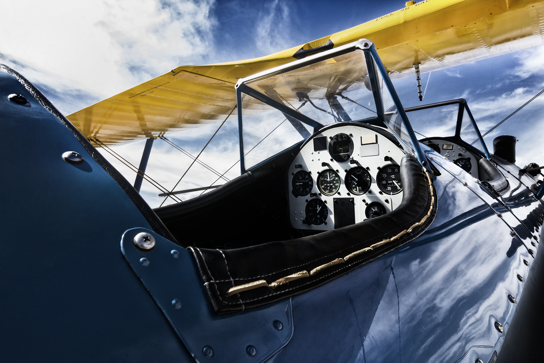 This nostalgic photo treatment of a bi-wing aircraft cockpit adds to the historical appeal aviation had in the early 1900's.