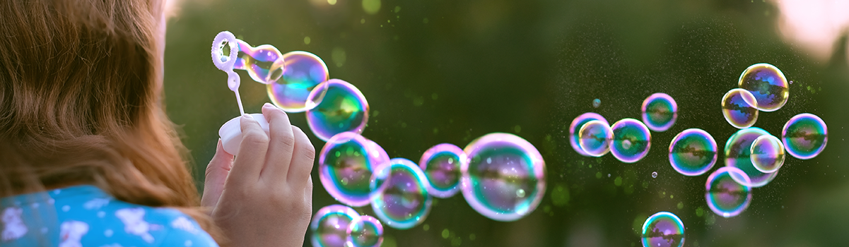 Person blowing lots of bubbles into the air