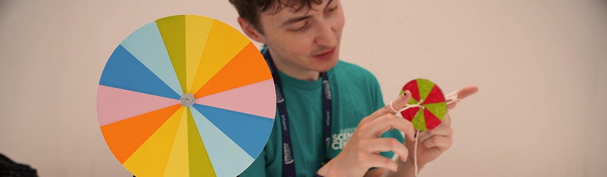 A science communicator demonstrates a Newton Disc