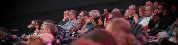 An audience listens to a speaker at a David Elder lecture in the Planetarium