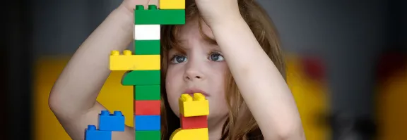 Girl building with giant lego