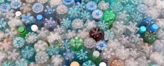 An assortment of plastic bottles packed together upside down.