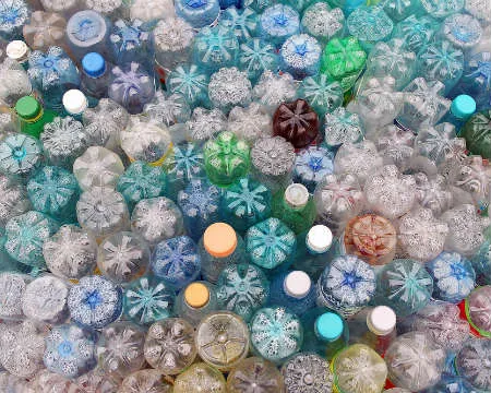 An assortment of plastic bottles packed together upside down.