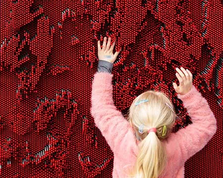 Girl using Pin Screen Wall exhibit