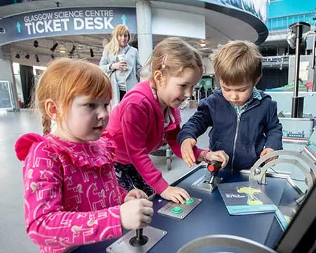 Ticket desk - children using exhibit