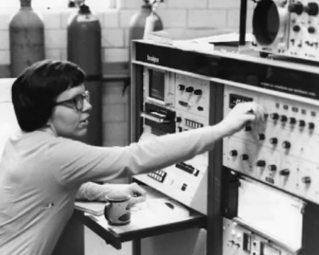 Female scientist working with gas chromatograph