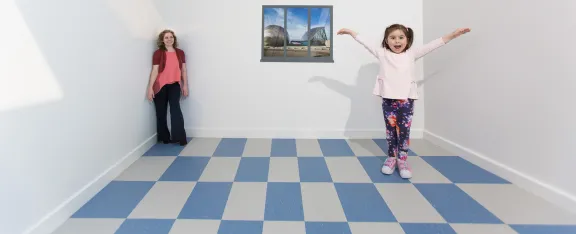 A child appears larger than an adult in the Ames room