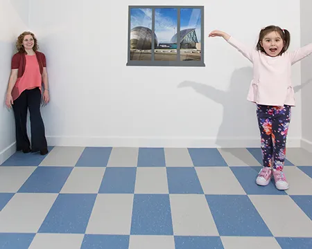 A child appears larger than an adult in the Ames room
