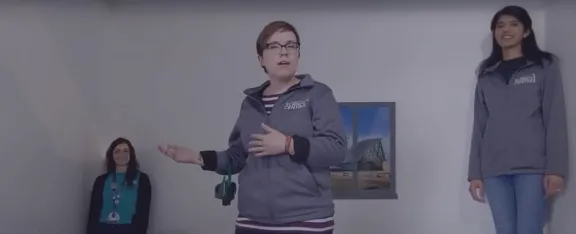 Three Science Communicators appear to be very different heights in the Ames Room