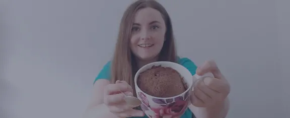 Presenter Amy holds up a cake in a cup
