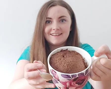 Presenter Amy holds up a cake in a cup