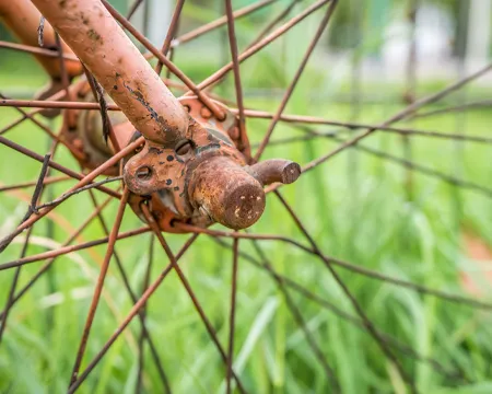 Close up with old rusted bicycle hub and spokes