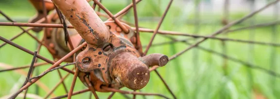 Close up with old rusted bicycle hub and spokes