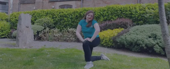 Presenter Amy doing tai chi style moves outside