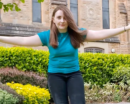 Presenter Amy with arms outstretched