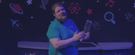 Presenter CJ holds a plastic bottle filled with hydrogen gas