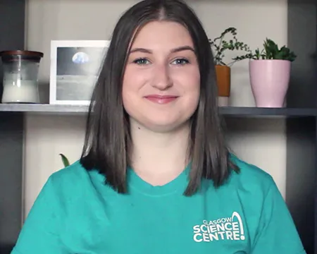 Presenter Natalie sits in front of a bookcase