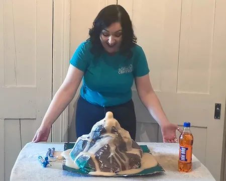 Presenter Veronica with a model volcano