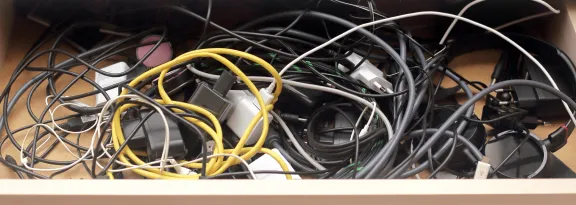 USB chargers and wires tangled and in chaos in drawer