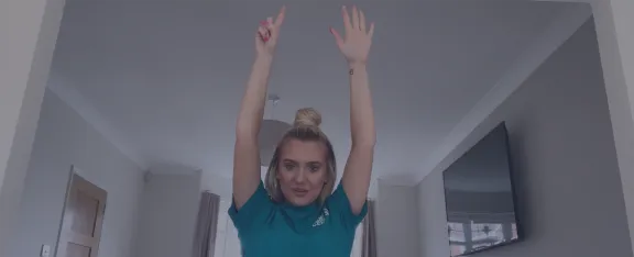 Presenter Celine with her arms stretched into the air.