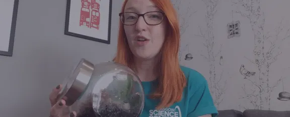 Presenter Jennifer holds a glass terrarium